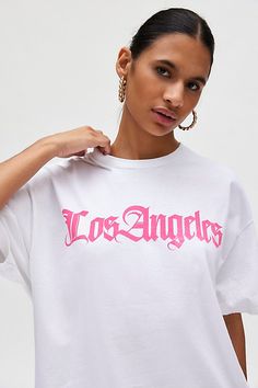 T-shirt dress featuring a Los Angeles destination graphic across the chest. Perfect as an oversized graphic tee or mini dress! Find it only at Urban Outfitters. Features Los Angeles Destination graphic t-shirt dress Oversized graphic tee Soft and stretchy jersey knit Crew neckline with drop shoulders and short sleeves Los Angeles graphic across the front Relaxed, slouchy fit Tunic length Easy pull-over style UO exclusive Content + Care 100% Cotton Machine wash Imported Size + Fit Model in White is 5’9.5" and wearing size S/M Measurements taken from size S/M Chest: 46" Length: 30.5" | Los Angeles Destination T-Shirt Dress in White, Women's at Urban Outfitters Urban Outfitters Letter Print T-shirt For Summer, Cotton Graphic Print T-shirt Dress With Short Sleeves, Urban Outfitters White T-shirt For Streetwear, Urban Outfitters Summer Text Print T-shirt, Urban Outfitters White Graphic T-shirt, Urban Outfitters White T-shirt With Graphic Print, Urban Outfitters White Graphic Print T-shirt, White T-shirt With Screen Print By Urban Outfitters, Urban Outfitters Graphic Tee With Text Print