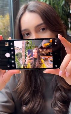 a woman taking a selfie with her cell phone