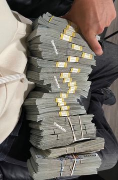 a man holding stacks of money in his hands