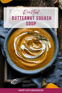 a bowl of butternut squash soup on top of a wooden table