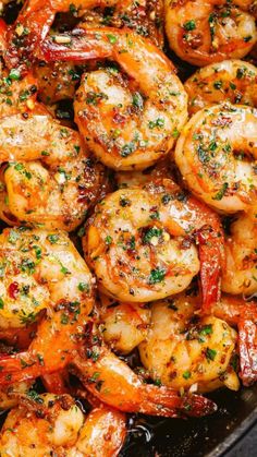 cooked shrimp in a skillet with parsley sprinkled on the top and sides