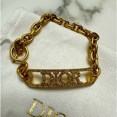 Brand New With Tags. 100% Authentic Dior Id Bracelet Style B1628dvocy The Dio(R)Evolution Bracelet Is Distinguished By Its Modern And Sophisticated Allure. The Gold-Finish Metal Design Reveals Chain Links And Is Further Embellished With A Silver-Reflective Crystal Pav ‘Dior’ Signature. Features Silver-Tone Crystals ‘Dior’ Signature Gold-Finish Metal Toggle Clasp Comes Exactly As Shown In Photos. Includes Dior Storage Bag. Designer Gold Bracelets With Logo Charm, Designer Silver Bracelets With Logo Charm, Luxury Bracelets With Logo Charm As Gift, Luxury White Gold Jewelry With Logo Charm, Designer Diamond Gold Bracelets, Designer Gold Diamond Bracelets, Designer Bracelets With Diamond Accents, Luxury Bracelets With Logo Charm For Formal Events, Designer White Gold Bracelets For Everyday Luxury