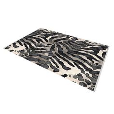 an animal print rug with black and white spots on it's surface, in the shape of a zebra pattern