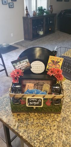 a record player sitting on top of a table next to a vase filled with flowers