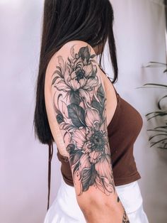 a woman with a flower tattoo on her arm