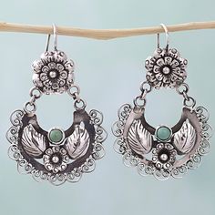 According to the Mazahua Family each piece of their jewelry is crafted by hand and all are reflections of our region's customs inspired by nature with traditional motifs like birds flowers and leaves. This pair of dangle earrings does that statement justice featuring two stones of natural turquoise surrounded by sterling silver floral filigree motifs. Bohemian Style Flower Drop Earrings, Bohemian Style Drop Flower Earrings, Luxury Bohemian Earrings With Intricate Design, Luxury Hand Tooled Silver Jewelry, Earrings Handmade Novica, Mexican Earrings Novica, Vintage Mexican Jewelry Novica, Mexican Silver Jewelry Novica, Cheap Turquoise Dangle Flower Earrings