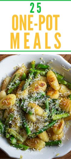 a white plate topped with pasta and asparagus