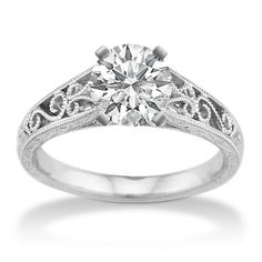 a diamond engagement ring with filigrees on the sides