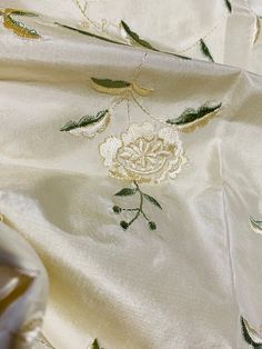 Traditional Machine Embroidered Fabric For Wedding, Silk Fabric With Intricate Embroidery For Celebration, Elegant Machine Embroidered Fabric For Festive Occasions, Elegant Cream Embroidered Fabric With Motifs, Elegant Cream Embroidered Fabric With Pallu, Elegant Floral Embroidered Fabric For Traditional Ceremonies, Traditional Gold Embroidered Fabric With Machine Embroidery, Traditional Gold Machine Embroidered Fabric, Ceremonial Cream Embroidered Dupatta