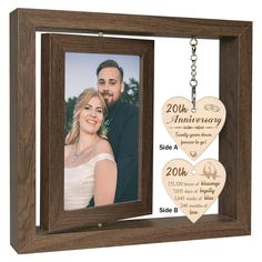 an anniversary photo frame with two hearts hanging from the front, and a key chain attached to it