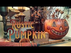 pumpkins and other halloween decorations are displayed in front of a sign that says rustic pumpkin