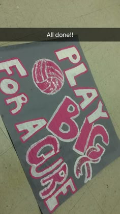 a gray and pink sign that says happy labor day on the ground with balls in it