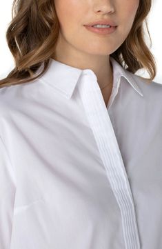 This beautifully tailored white hidden placket shirt fills the hole in your closet! Reach for this without even thinking! The perfect versatile shirt that can be worn for work or casually with denim. 27-1/2" HPS Hi-low hem detail Pintuck details Hidden placket button front closure Rolled sleeves with button tab closure 65% Cotton, 32% Polyester, 3% Spandex Shirt Without Buttons, Sf Style, Poplin Blouse, Bar Workout, Liverpool Jeans, Rolled Sleeves, Denim Details, Woven Top, Pin Tucks