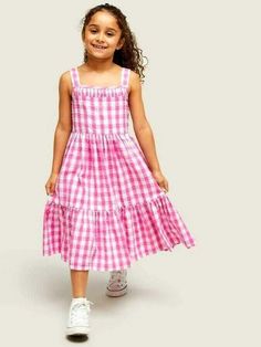 Decorated in all-over checks, this tiered dress from our own collection is made from pure cotton that's soft against little one's skin. Fully lined for ultimate comfort, it's defined by smocked back detailing and a flared bottom tier. Pair with pumps for the perfect look. Details: 100% Cotton Casual Gingham Tiered Dress, Casual Tiered Gingham Dresses, Cotton Tiered Smock Dress, Cotton Smock Tiered Dresses, Playful Cotton Smocked Summer Dress, Cotton Smocked Dress With Ruffles For Picnic, Summer Plaid Smocked Dress For Picnic, Plaid Smocked Dress For Summer Picnic, Plaid Smocked Dress For Summer Picnics