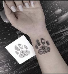 a person with a dog paw tattoo on their arm