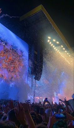 the crowd is watching an artist perform on stage