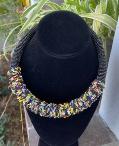 The Akuleau beaded choker style necklace is a choker style with solid color beads and colorful embellishment. Very lightweight and colorful. Ladies of Baskets and Beads in Kenya modeling many of the necklaces. Note: beaded embellishment may be slightly different than pictured. Rope Jewelry, Choker Style Necklace, Beaded Rope, Color Beads, In Construction, Choker Style, Black Choker, Beaded Choker, Style Necklace