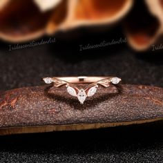 a diamond ring sitting on top of a piece of wood