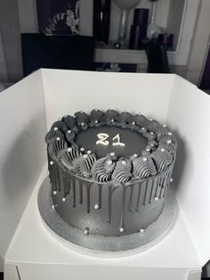 a birthday cake in a white box with the number twenty four on it's side