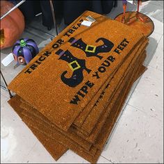 a pile of halloween door mats sitting on top of a floor