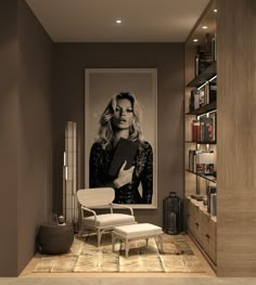 a woman is holding a book in her hand while standing next to a chair and bookshelf