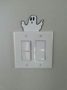 a white light switch sitting on top of a wall