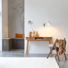 a wooden table sitting next to a white rug