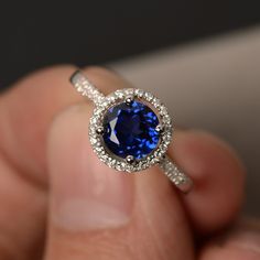 This is a gorgeous handmade creation. Its beauty is its simplicity & Elegance.  The 7*7mm round cut lab created sapphire is crafted in solid sterling silver and with rhodium plated. All item is sent in a beautiful gift box You can realize more lovely stuff clicking the link https://www.etsy.com/shop/knightjewelry?refshopsection_shophome_leftnav Please leave the correct address and you phone number for delivering successfully. Round Sapphire Engagement Ring, Blue Sapphire Engagement Ring Halo, Engagement Rings Blue, Blue Gemstone Ring, Rings Blue, Sapphire Engagement Rings, Blue Engagement Ring, Pastel Beads, Blue Gemstone Rings