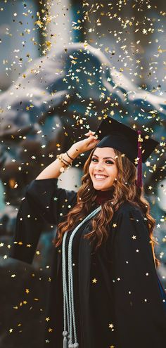 a woman in graduation cap and gown standing under confetti falling from the sky