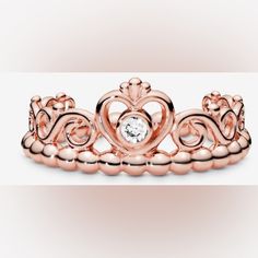 a rose gold crown ring with a diamond