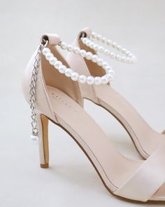 Classic satin high heel sandals adorned with adjustable ankle pearls for romantic, elegant and feminine look. Simple and easy wear for bridal wear, bridesmaids, holiday party, wedding parties, and any special occasions. DETAILS:HEEL HEIGHT: 3.5 InchesUPPER: Synthetic upper and liningMATERIALS: Manmade outsole