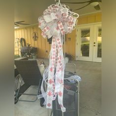 a bunch of luggage that is tied to a pole in front of a building with a door