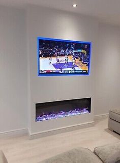 a large flat screen tv mounted to the side of a wall in a living room