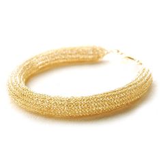 A chunky tube bangle Bracelet , the bangle is tight knitted and has a unique ethnic flair. This bangle has the look of a jewelery that has been around for centuries , and will stay around for a couple more, you will feel very special wearing it. The bangle Bracelet length : 7 inch (18cm) plus a short extension for better adjustment to your wrist. the tube diameter is : 4 inch (1cm) the bangle bracelet is made of quality gold filled wire 1/20, it can be ordered in rose gold or silver as well. ~~~~~~~~~~~~ Want to LEARN how to make my jewelry yourself ? Follow the link Handmade Bangle Chain Bracelet For Party, Elegant Handmade Hoop Bracelet, Elegant Handmade Braided Bangle Bracelet, Wire Crochet, Crochet Bracelet, Bangle Bracelet, My Jewellery, Gold Filled, Bangle Bracelets