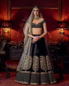 This Deep Blue Color Wedding lehenga is in silk velvet embroidered with thread and zardozi work. Dupatta is in gold color net fabric with embroidered edges and sequins butties inside. Blouse is also fully embroidered. Elegant Ceremonial Lehenga With Traditional Drape, Elegant Traditional Drape Lehenga For Ceremony, Elegant Gown With Pallu For Ceremony, Elegant Ceremony Gown With Pallu, Elegant Fitted Sharara For Ceremony, Blue Luxury Wedding Sets, Luxury Blue Wedding Sets, Ceremonial Lehenga With Pallu, Elegant Saree Sets For Ceremony