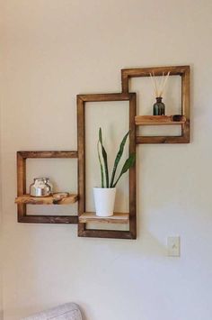 three square wooden shelves with plants in them