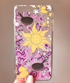 a hand holding up a phone case with flowers on the front and bottom, while it is