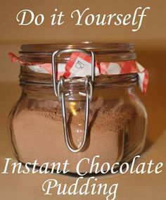 a jar filled with chocolate pudding sitting on top of a wooden table next to a sign that says, do it yourself instant chocolate pudding