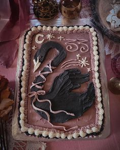 there is a cake that looks like a bird on it's side, with icing in the shape of a hand