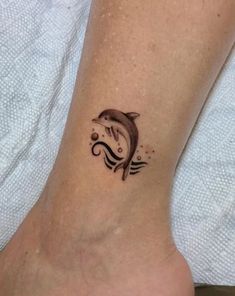 a small dolphin tattoo on the ankle