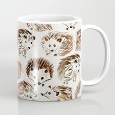 a white coffee mug with hedgehogs on it