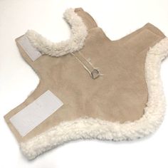 a tan sheepskin coat with shears on it