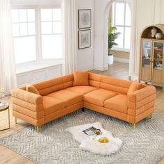 an orange sectional sofa sitting on top of a rug