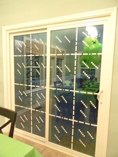 a dining room with green table cloths and white window panes on the wall