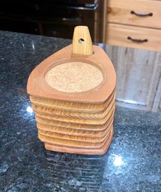 a stack of wooden coasters sitting on top of a counter