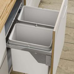 an open drawer in a kitchen next to a counter