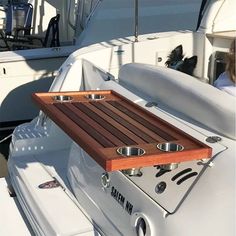 there is a wooden tray on the back of a boat