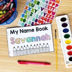 the name book savannah is next to some crayons and markers on a table