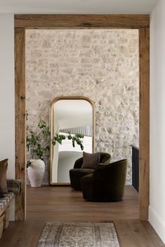 a living room with a chair and mirror