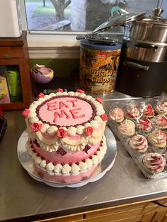 there is a cake and cupcakes on the counter